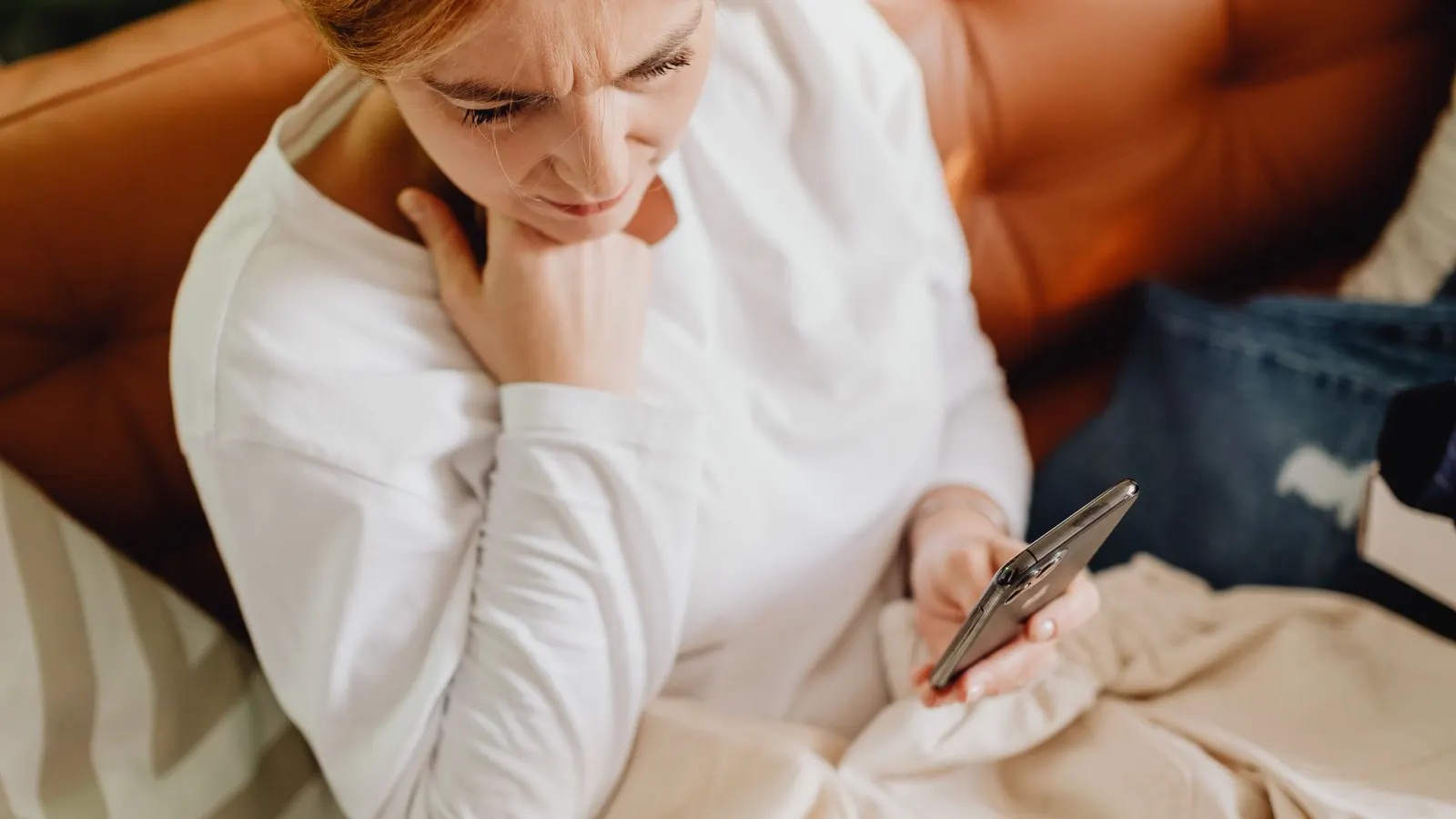 Mujer preocupada mirando la pantalla de su celular